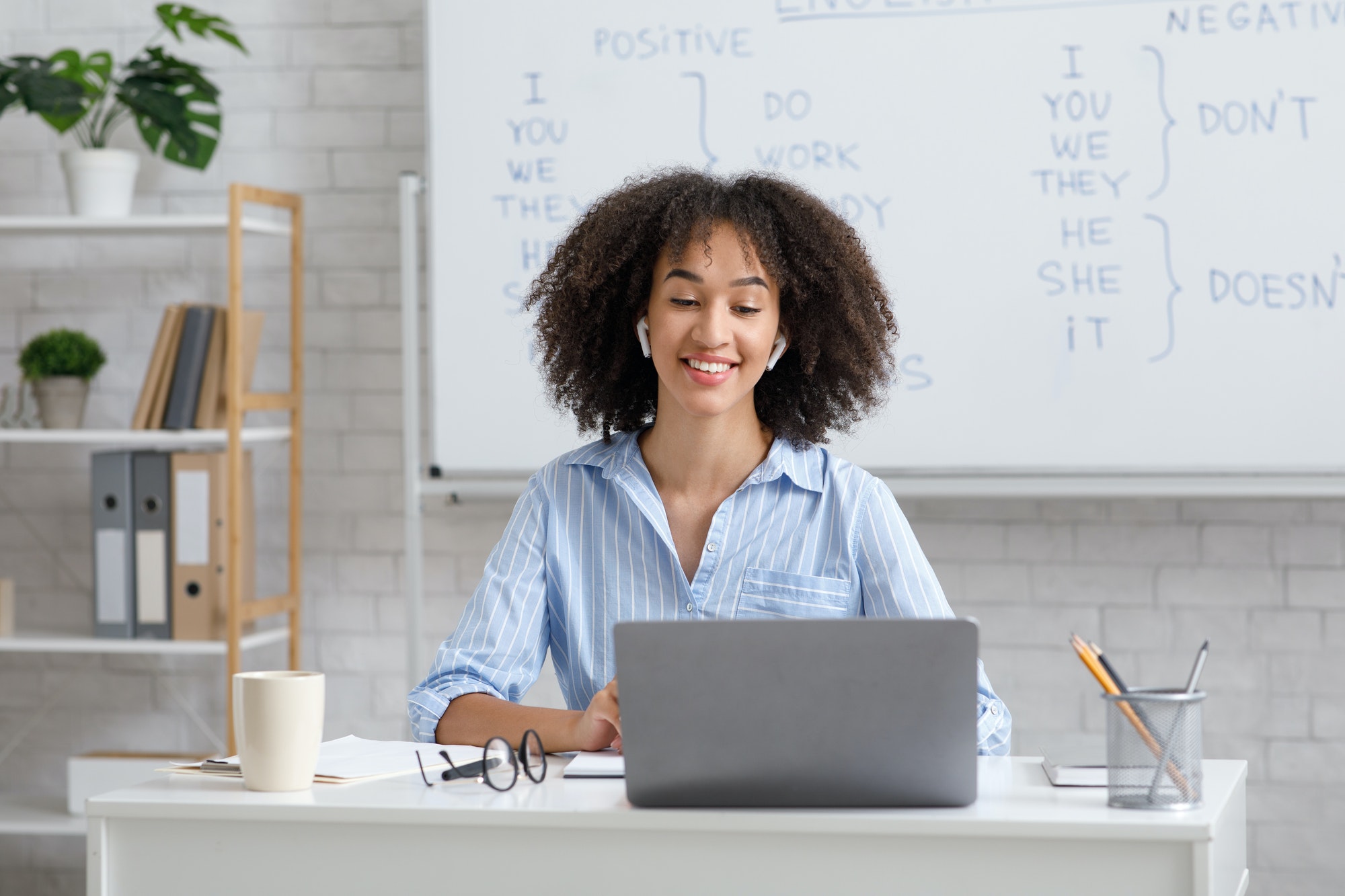teacher works online during quarantine woman chatting with students at online lesson in living room